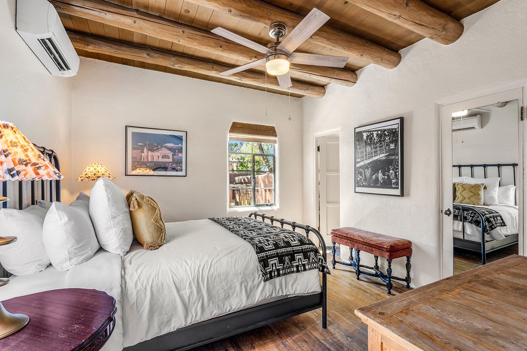 Unwind in your charming bedroom featuring vigas, cozy linens, and southwestern charm that invites peaceful nights and relaxed mornings.