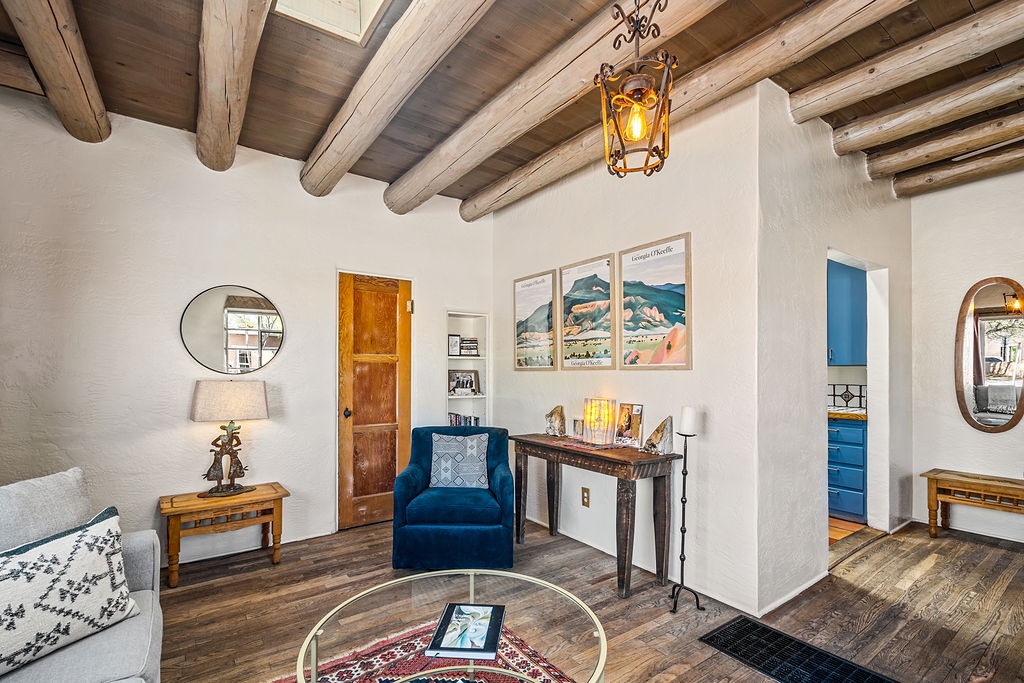 Relax under stunning wood beams in your stylish living room with cozy seating and warm lighting that makes every evening feel special.