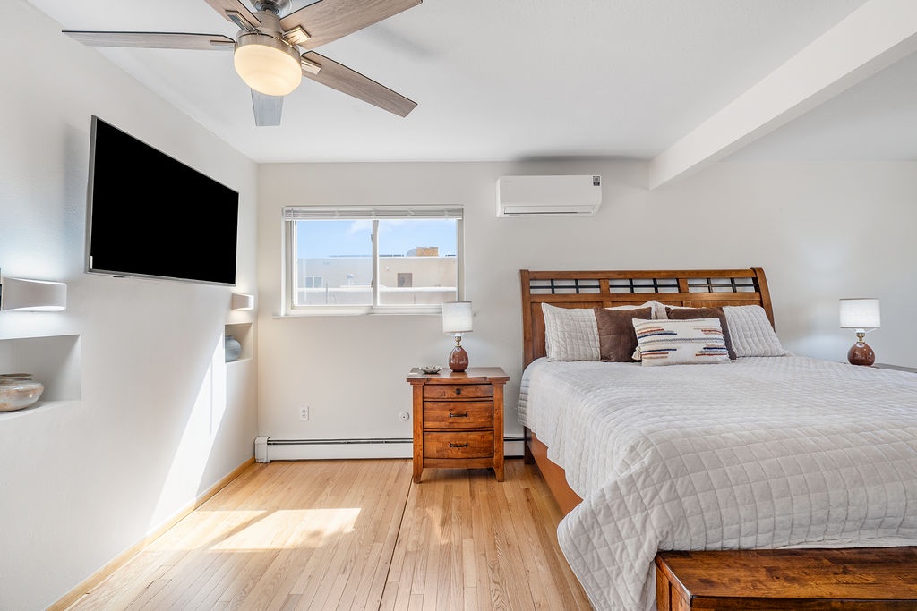 Rest easy in your bright, airy bedroom with warm wood floors, cozy linens, and all the comforts you need for a peaceful stay.