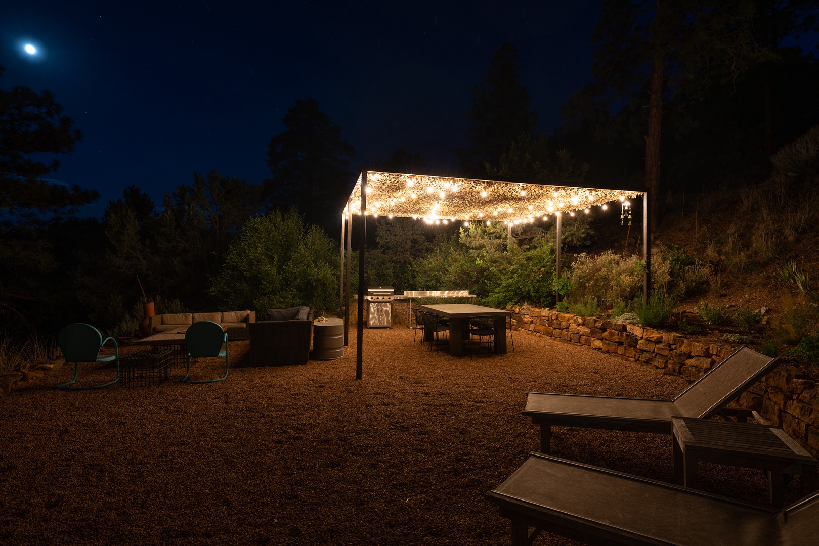 This beautifully lit outdoor space offers a magical evening retreat under twinkling lights. Unwind in cozy lounge seating, gather around the fire pit, or dine al fresco beneath the stars.
