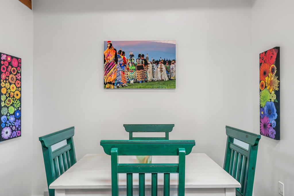 Gather around your bright dining table surrounded by vibrant local artwork that brings color and culture to every meal.