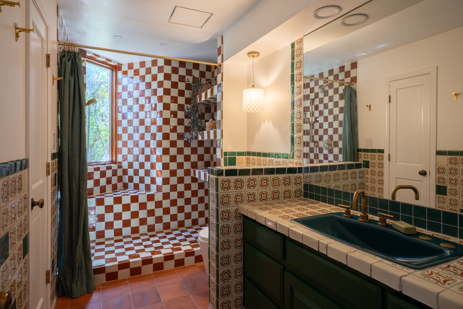 Step into your private retreat with distinctive checkerboard tilework, a sun-drenched window, and artisan details that create a uniquely charming space just for you.