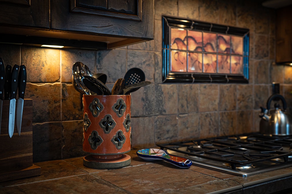 Your fully equipped kitchen invites culinary adventures with rustic charm and warm ambiance.