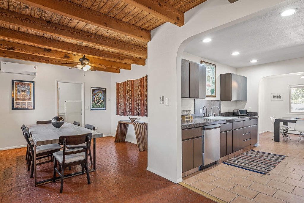 Your open-concept space blends rustic charm with modern convenience, featuring exposed wood beams and a sleek kitchen perfect for memorable meals.