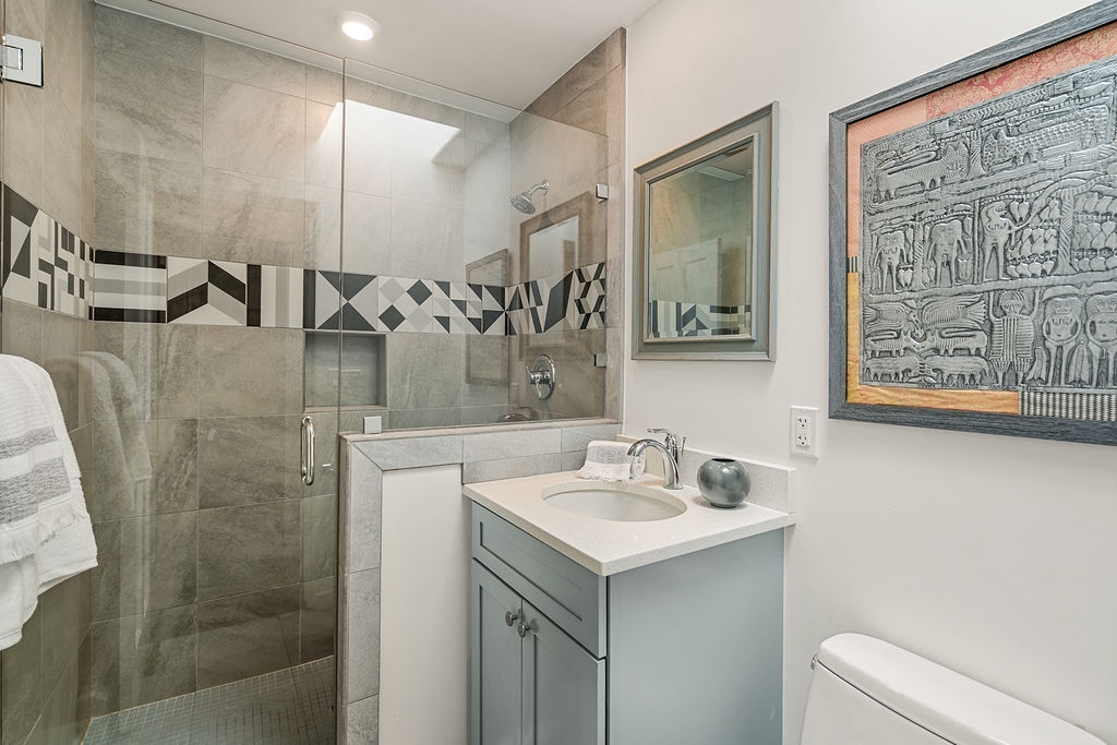 Refresh in your private bathroom with custom tiled shower, stylish vanity, and thoughtful design touches that make every morning feel like a spa experience.