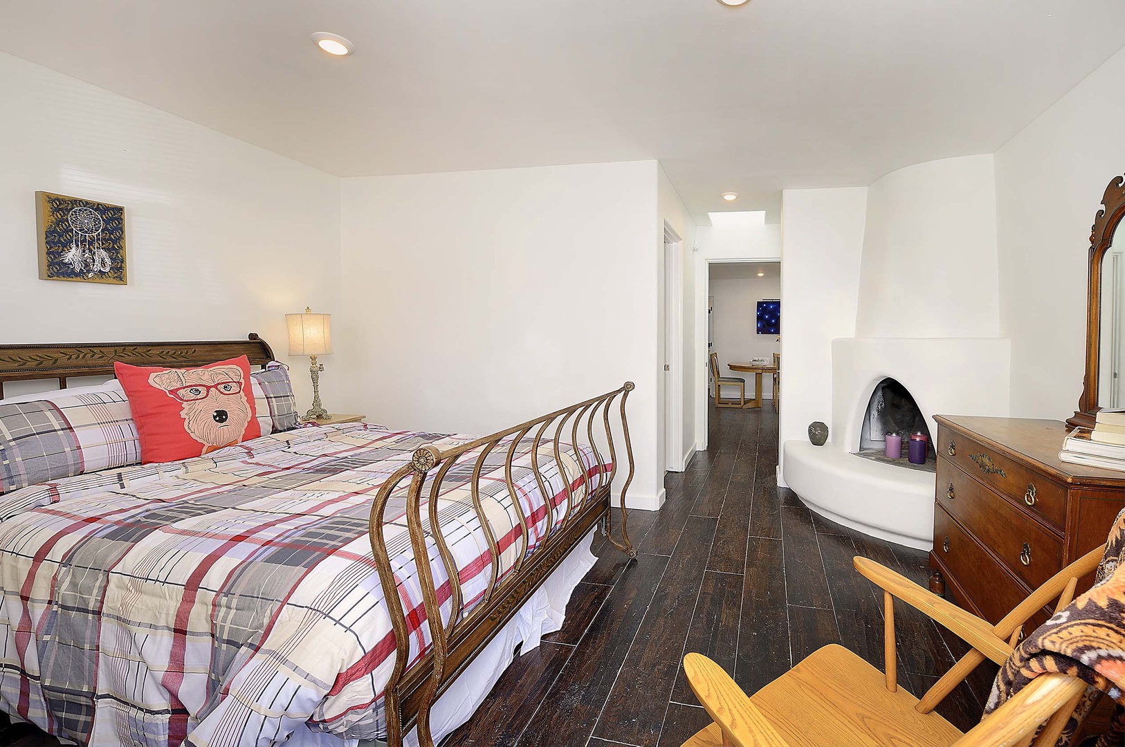 Cozy up by your private fireplace after exploring, with charming plaid linens and rustic touches creating the perfect mountain retreat vibe.