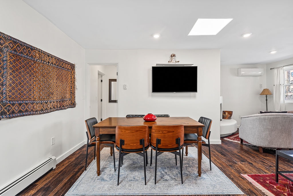 Gather around your elegant dining table for memorable meals, with entertainment just a glance away on the wall-mounted TV.