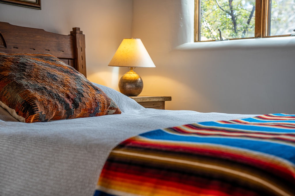 Drift into peaceful slumber with warm bedside lighting and handcrafted textiles that create your perfect cozy retreat.