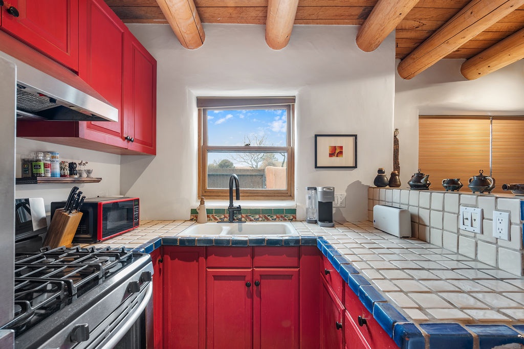 Cook memorable meals in your vibrant Southwest kitchen with handcrafted tile counters, exposed wood beams, and mountain views beyond.
