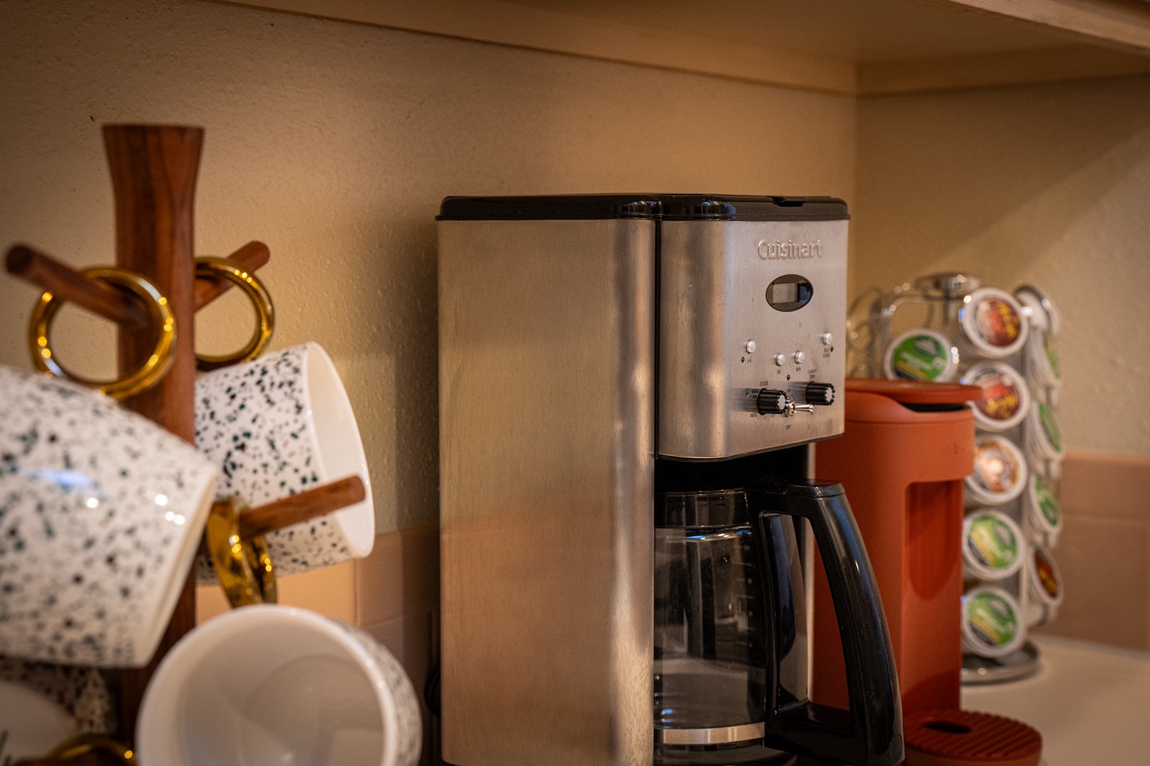 Start your mornings right with a fully equipped coffee station featuring a premium Cuisinart coffee maker and convenient K-cup holder for your perfect brew.