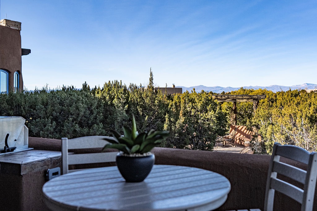 Enjoy morning coffee on your private terrace, overlooking lush gardens and distant mountains in perfect tranquility.