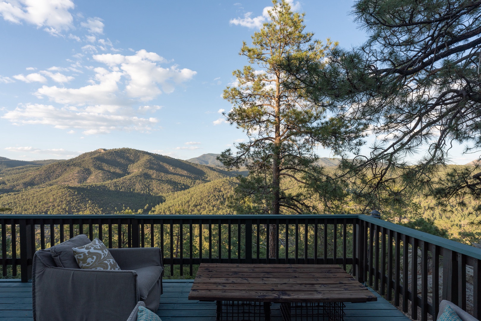Relax on your private deck with sweeping mountain views, framed by towering pines. Sip morning coffee or watch the day unfold in peaceful serenity.