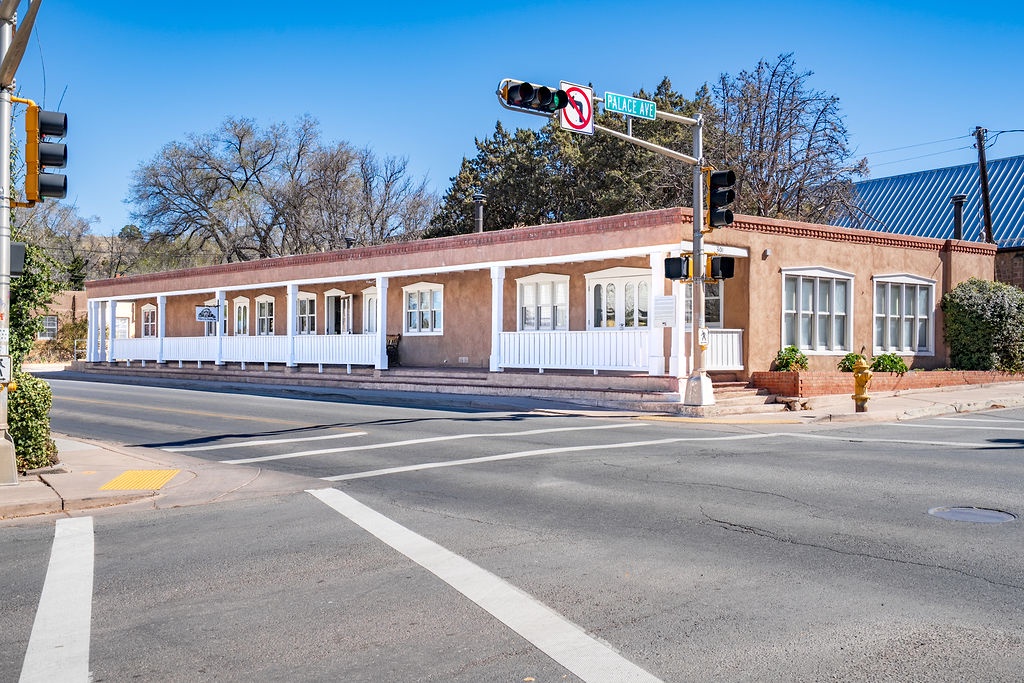Historic adobe building anchors the corner of Galisteo Street, showcasing authentic southwestern architecture in this charming neighborhood setting.