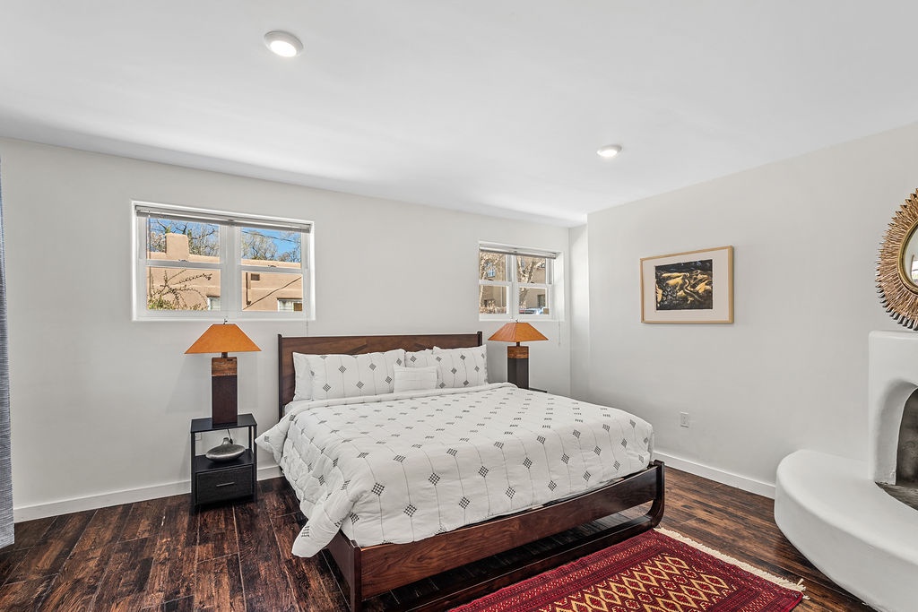 Wake up refreshed in your bright, modern bedroom featuring rich hardwood floors and elegant furnishings for a perfect night's rest.