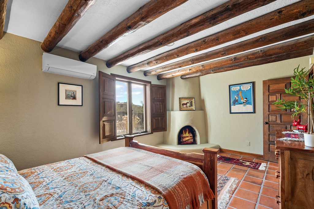 Cozy up in your charming bedroom with rustic wooden beams, a crackling fireplace, and handcrafted furnishings that create the perfect retreat.