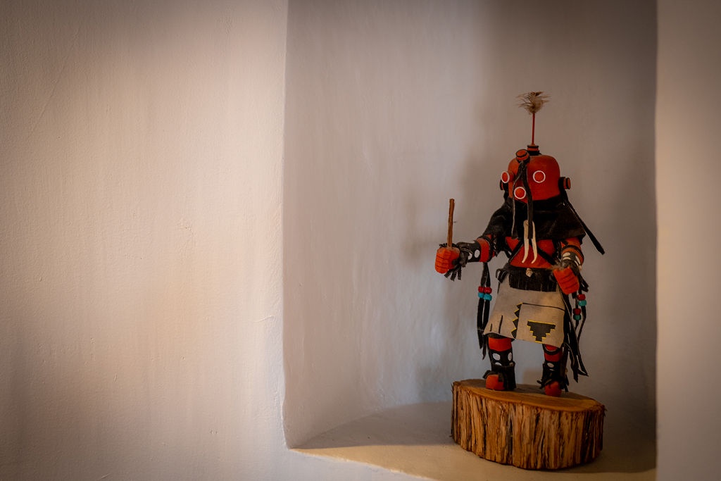 A striking Native American kachina doll creates an authentic cultural focal point in your peaceful corner retreat.