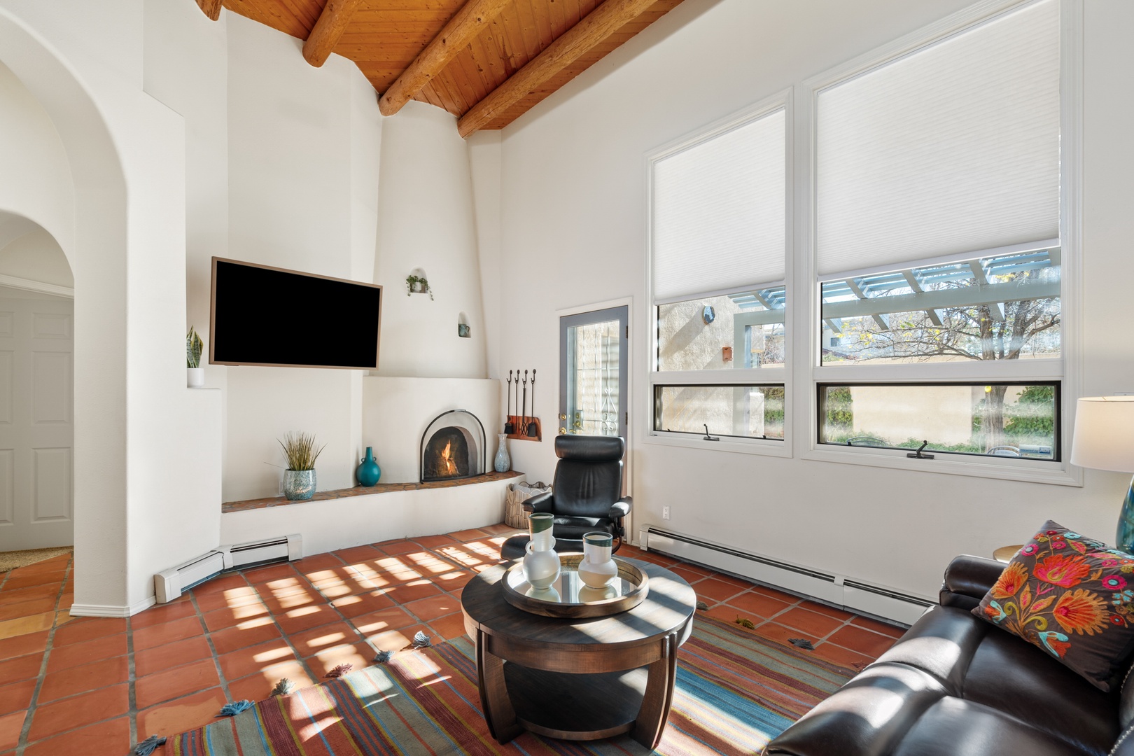 living room featuring rustic wood beams, a cozy fireplace, and comfortable seating where you can unwind after exploring the area.