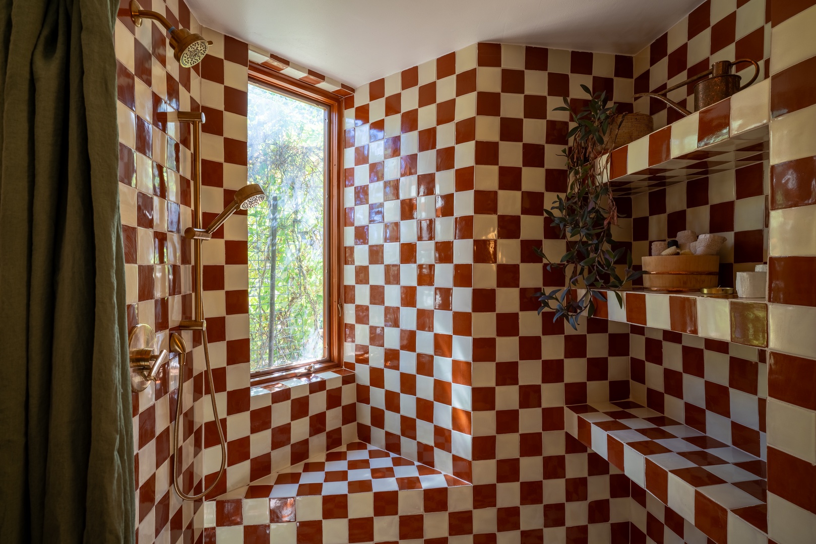 Refresh beneath a gleaming rain shower surrounded by vibrant checkerboard tiles and natural greenery, with sunlight streaming through the window to brighten your morning routine.