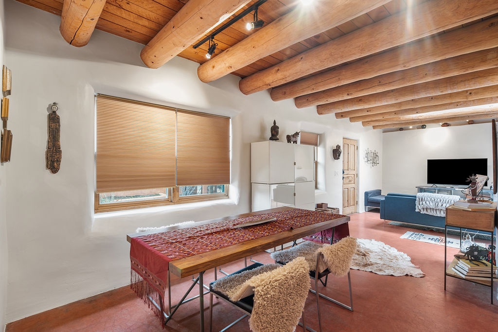 Unwind in your stylish living space featuring stunning wood beam ceilings, cozy seating, and southwestern charm throughout.