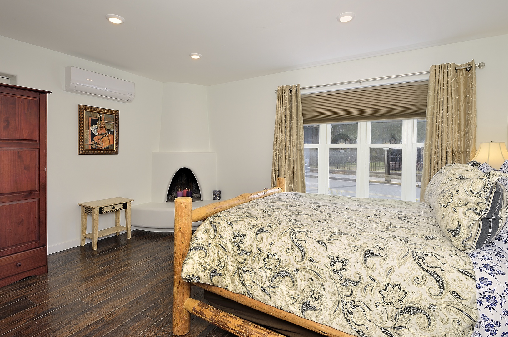 Cozy bedroom with charming fireplace and elegant paisley bedding invites restful nights in your peaceful retreat.