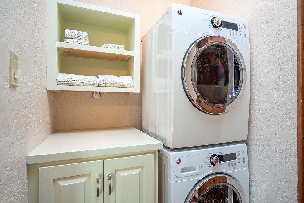 Your private laundry room features a stacked washer-dryer and built-in storage with fresh towels for ultimate convenience.