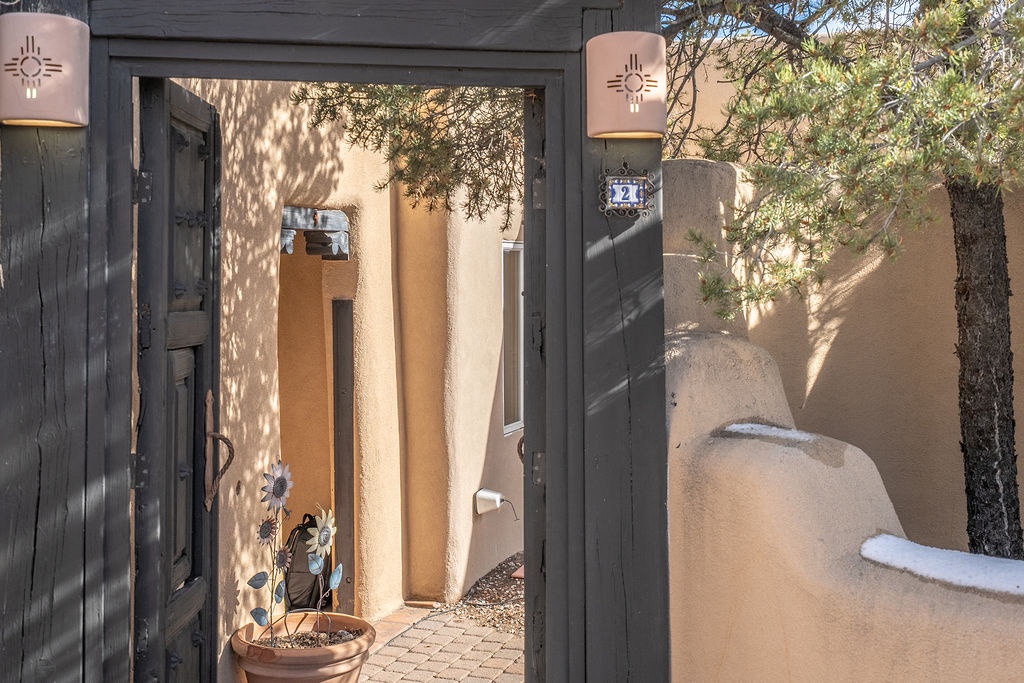 Step through charming gates into your private Southwest-style courtyard, where authentic adobe walls and decorative lighting create a welcoming entrance.