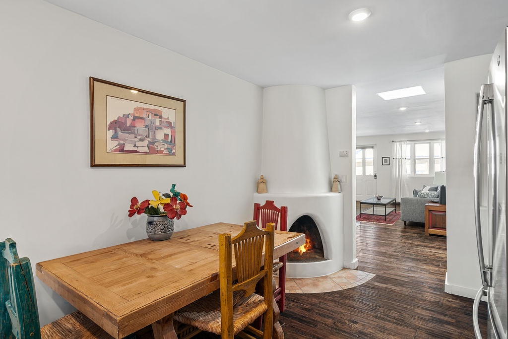 Your dining space features a warm wood table beside a crackling fireplace, creating the perfect cozy spot for meals and conversation.