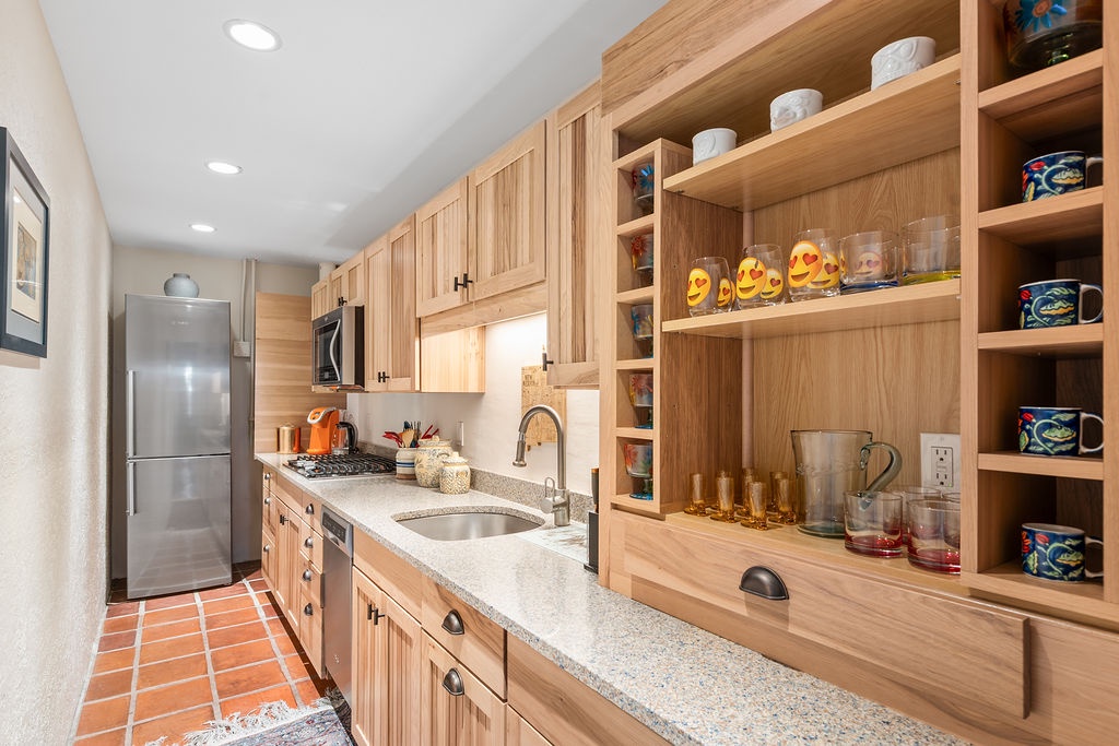 Your fully equipped kitchen features warm wood cabinetry, granite countertops, and everything you need to prepare memorable meals together.