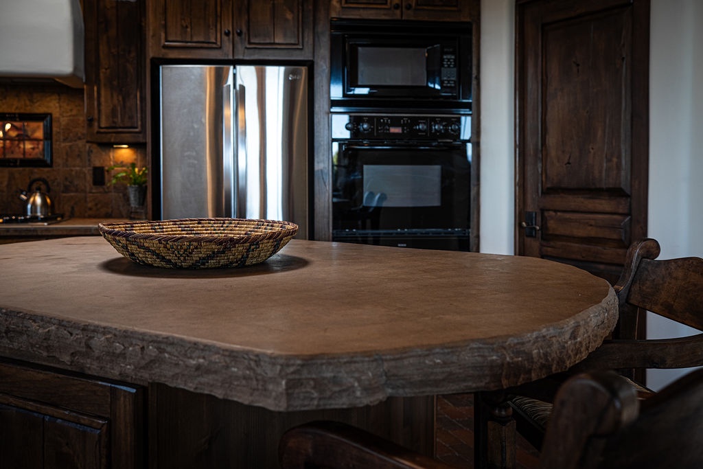 Gather around your spacious kitchen island where rustic wood meets modern convenience, perfect for morning coffee or sharing meals together.