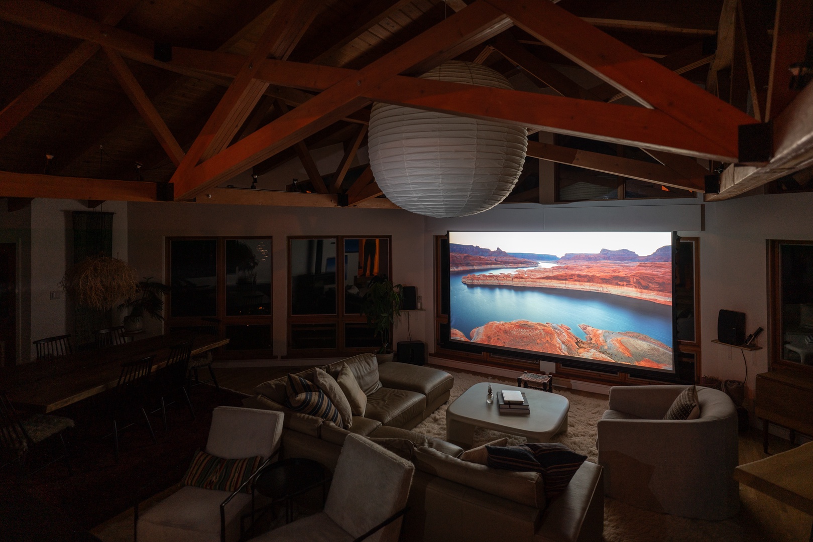 Gather under vaulted wood beams in your spacious living area, where plush seating and a massive screen invite cozy movie nights after exploring the high desert landscapes just outside.