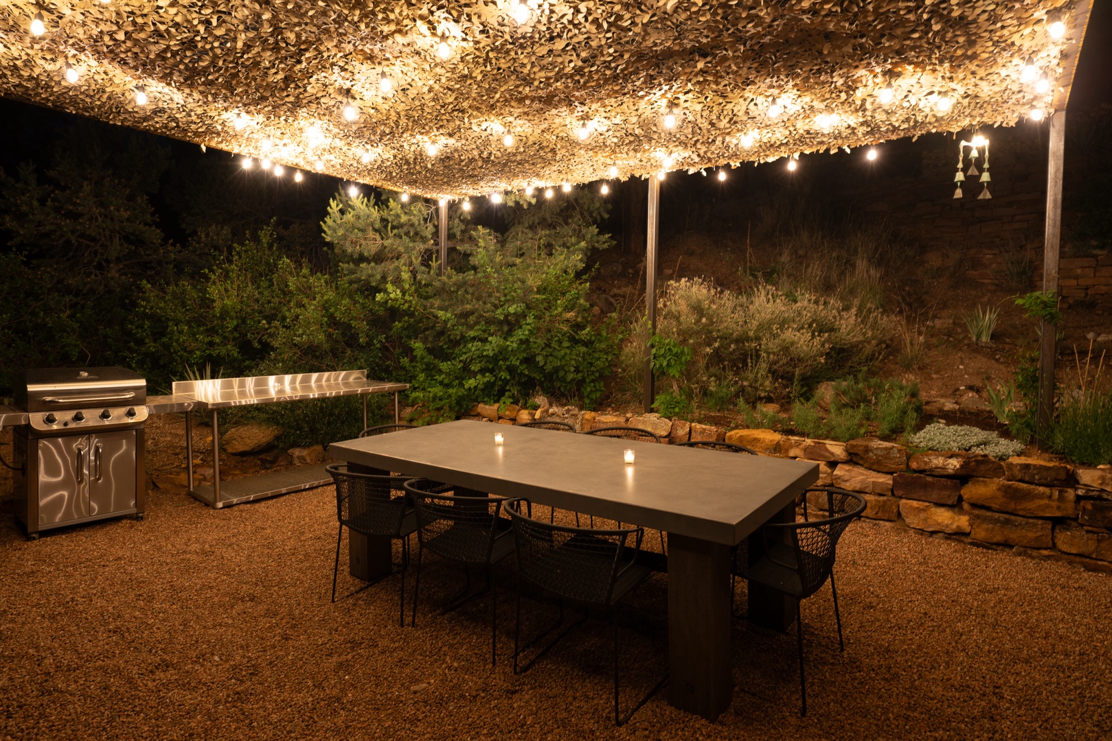 Your private patio glows under a canopy of twinkling lights, perfect for evening meals and starlit conversations around the dining table.