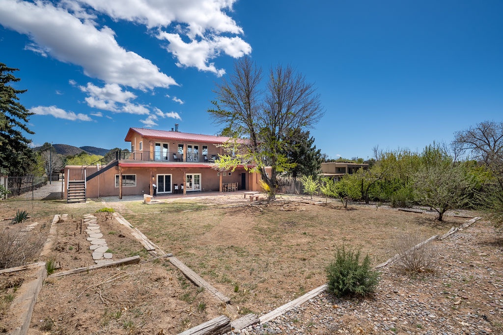 Peaceful adobe-style home with mountain backdrop and natural landscape surroundings in a tranquil desert setting.