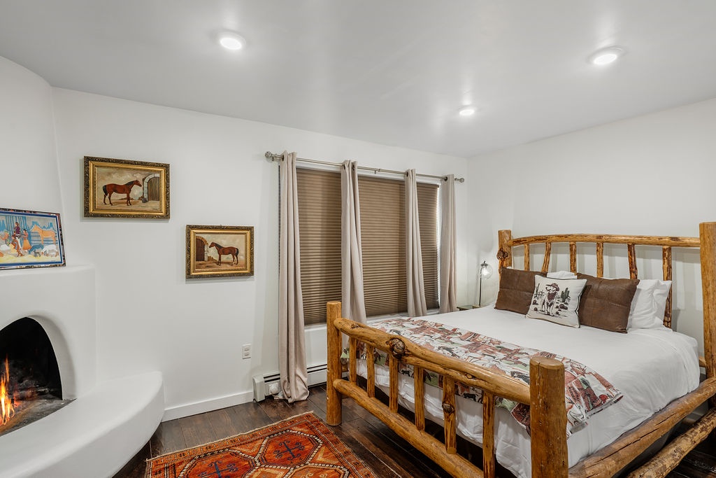 Cozy up in your rustic bedroom where a crackling fireplace and handcrafted log bed create the perfect mountain retreat atmosphere.