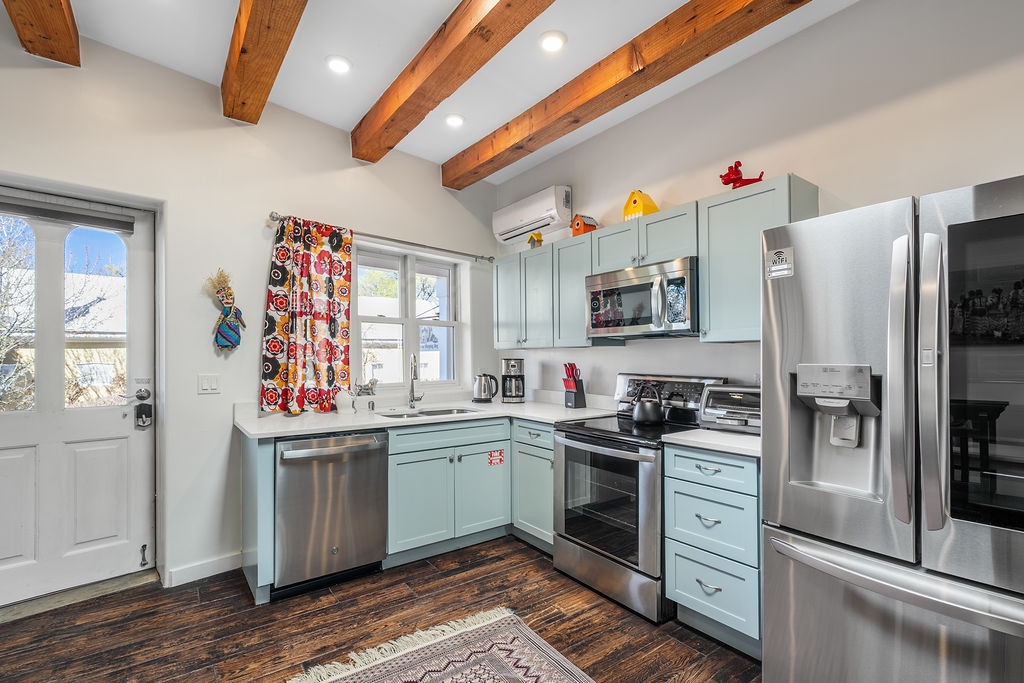 Your fully equipped kitchen awaits with modern appliances, exposed beams, and cheerful touches that make cooking feel like home.