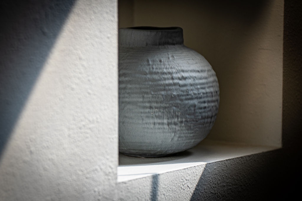 Beautiful ceramic vase adds artistic charm to your private shelving space, creating a warm, curated atmosphere.