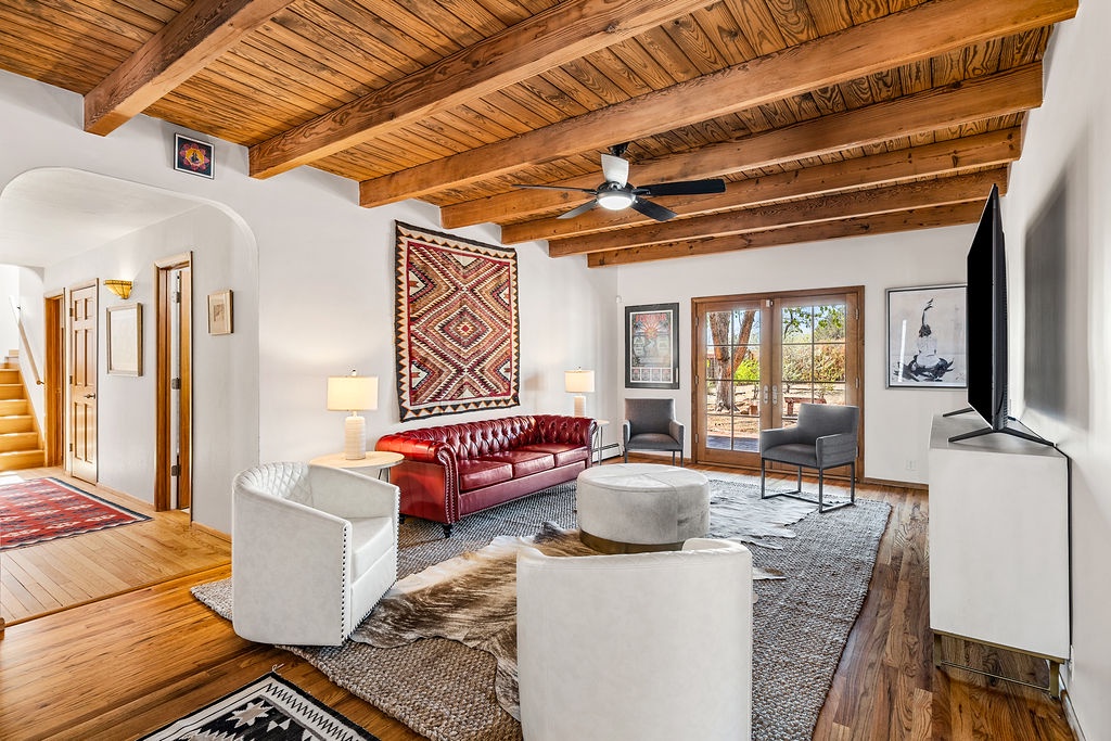 Relax in your stylish living room with soaring wood beam ceilings, handwoven textiles, and warm natural light streaming through the windows.