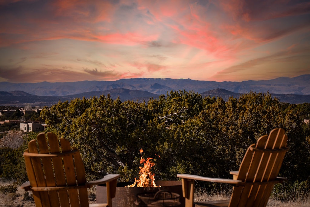 A spectacular fire pit setting with mountain views paints the perfect backdrop for evening relaxation under vibrant desert skies.