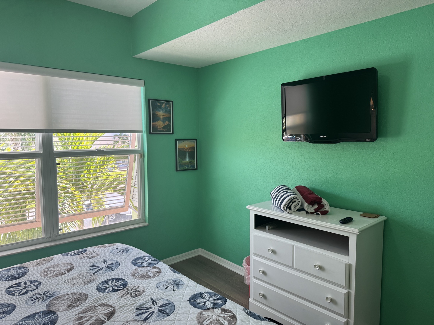Relax in your cheerful turquoise bedroom with palm-shaded views, a flat-screen TV for unwinding, and convenient storage for all your vacation essentials.