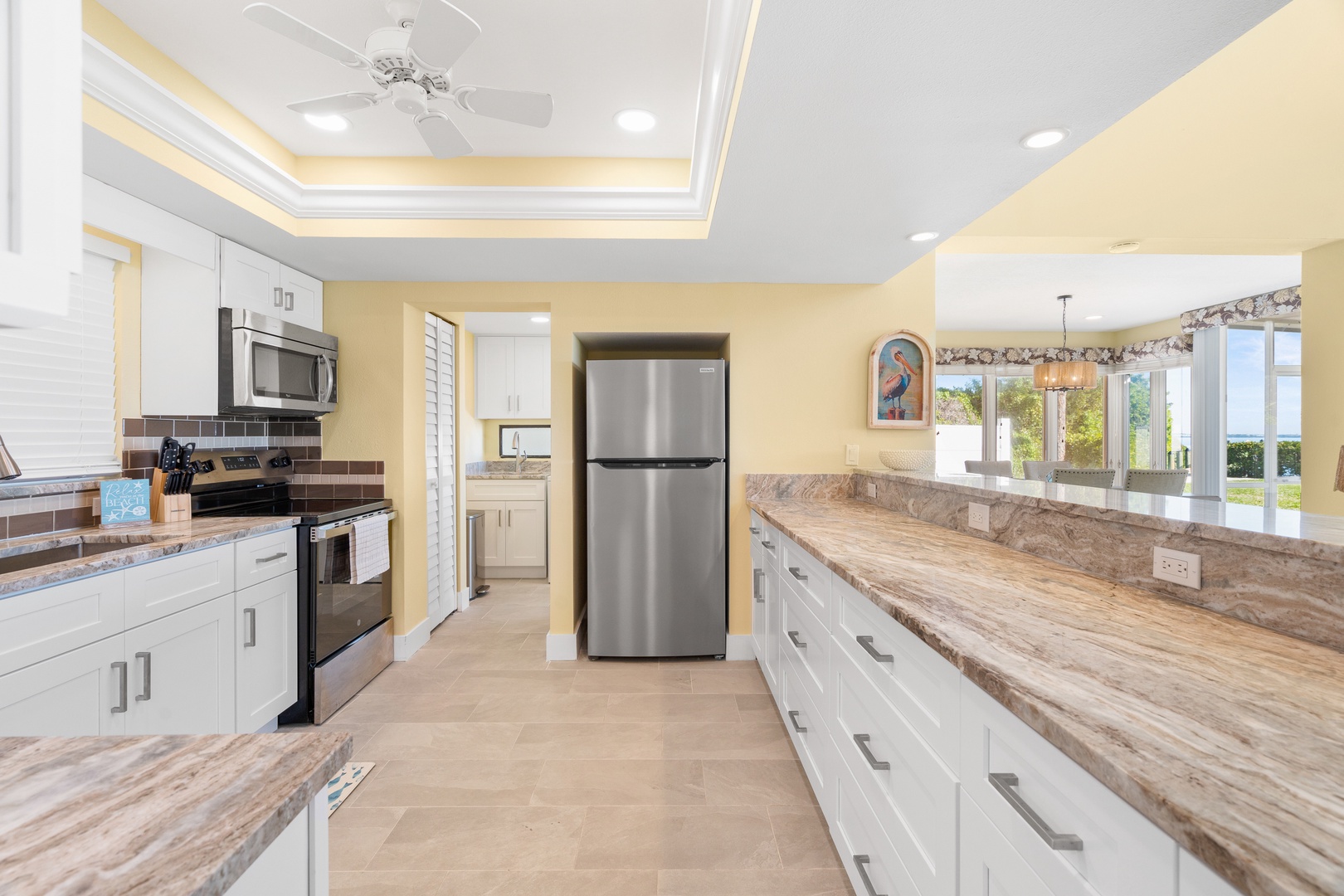 Prepare memorable meals in this stunning modern kitchen with granite countertops, stainless steel appliances, and abundant cabinet space for all your culinary adventures.