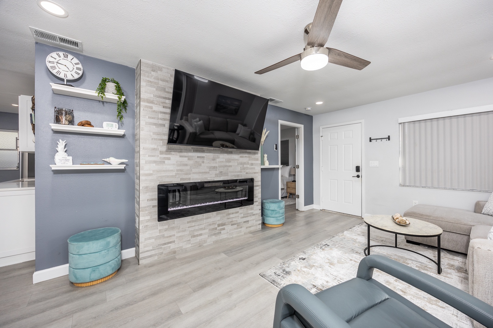 Unwind in your stylish living space featuring a cozy fireplace and modern entertainment center for perfect relaxation.