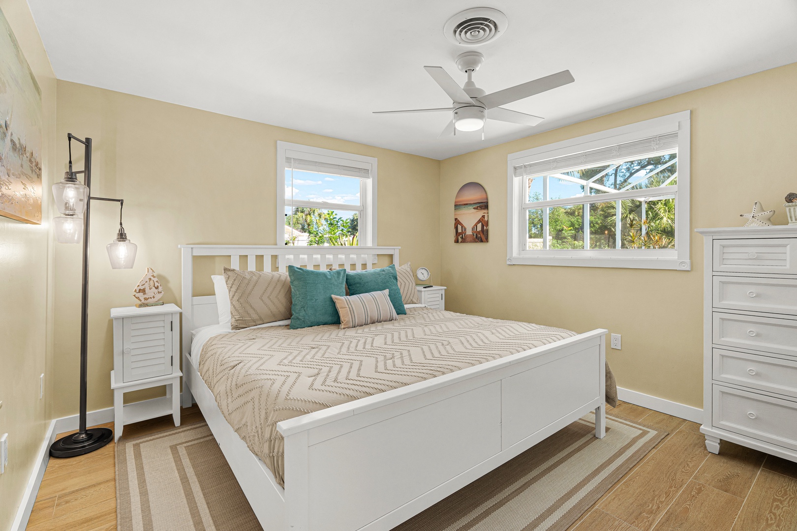 Sink into soft linens and let the gentle ceiling fan breeze lull you to sleep. Your sunny bedroom features coastal charm and plenty of natural light to wake up refreshed.