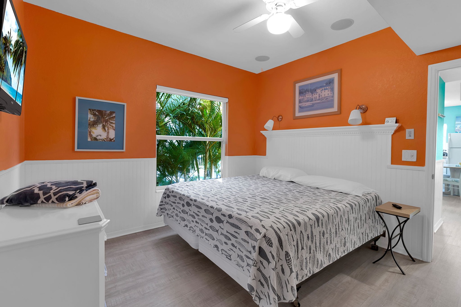 Drift off in your vibrant, sun-kissed retreat with tropical views framing the lush palms outside your window—perfect for peaceful mornings and restful nights.