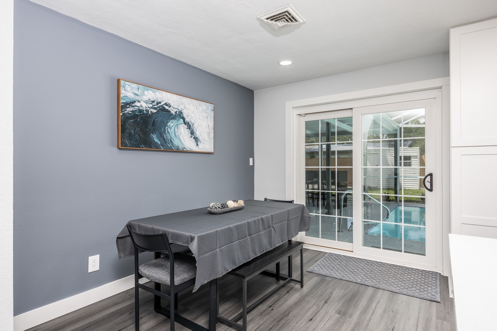 Relax at your private treatment table while enjoying serene poolside views through floor-to-ceiling windows in this peaceful wellness space.