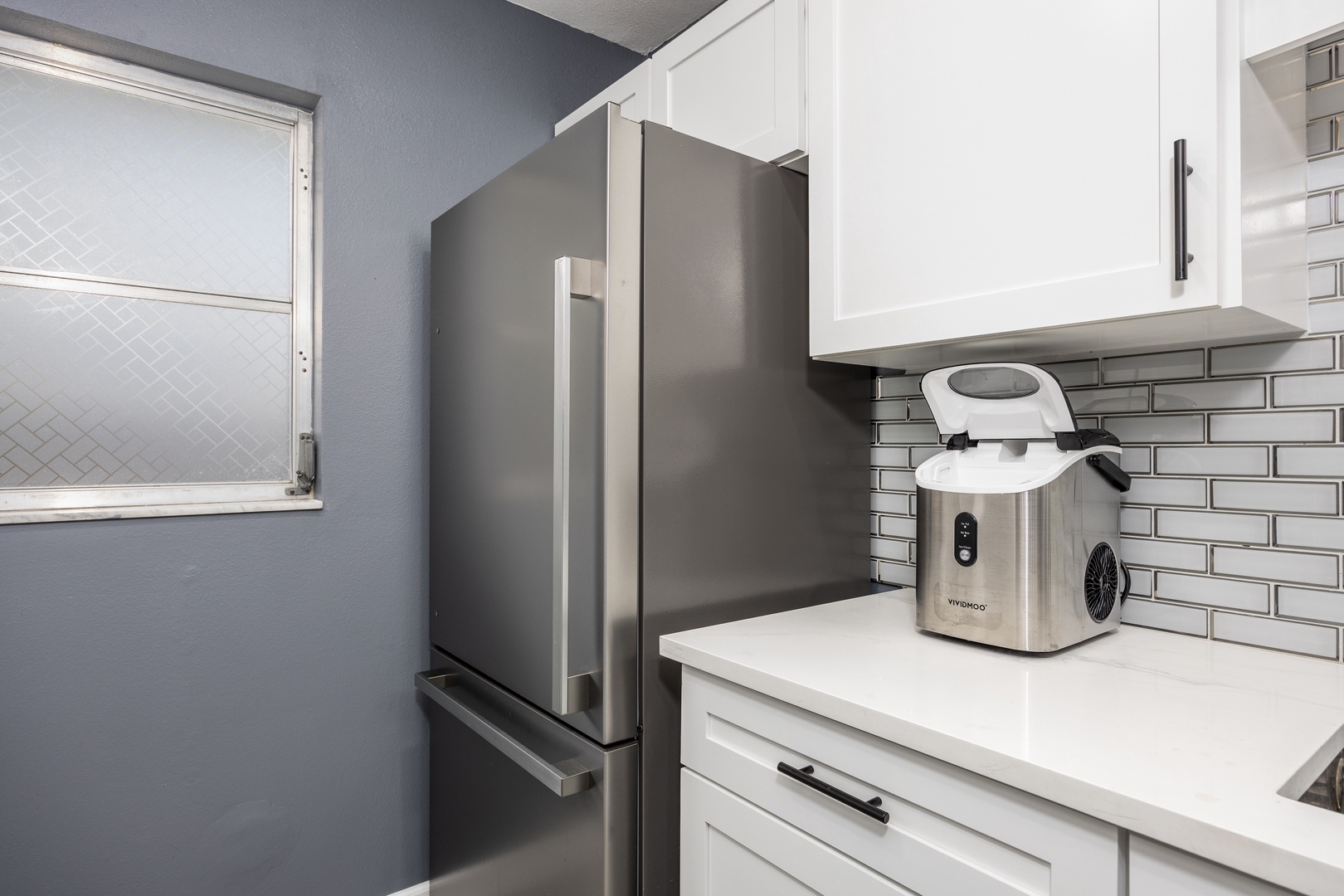 Your modern kitchen features sleek stainless steel appliances and stylish subway tile backsplash for effortless meal prep.