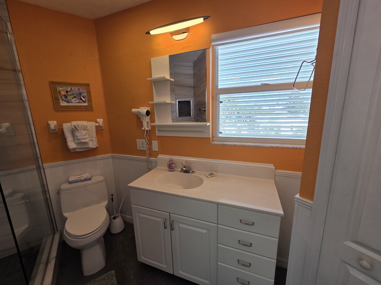 Your private bathroom features a spacious vanity with plenty of storage, fresh towels, and natural light—everything you need to feel refreshed and at home during your stay.