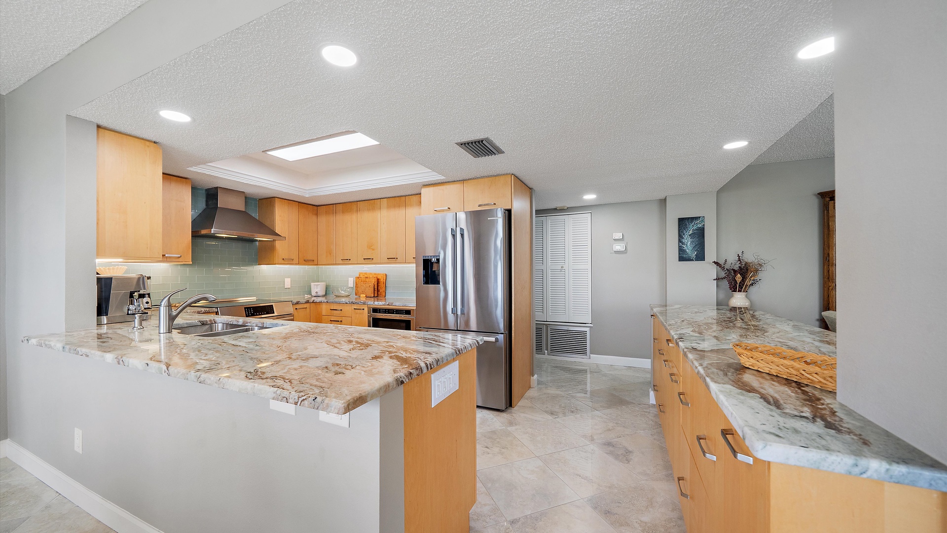 You'll love preparing meals in this stunning modern kitchen with granite countertops, stainless steel appliances, and abundant counter space.