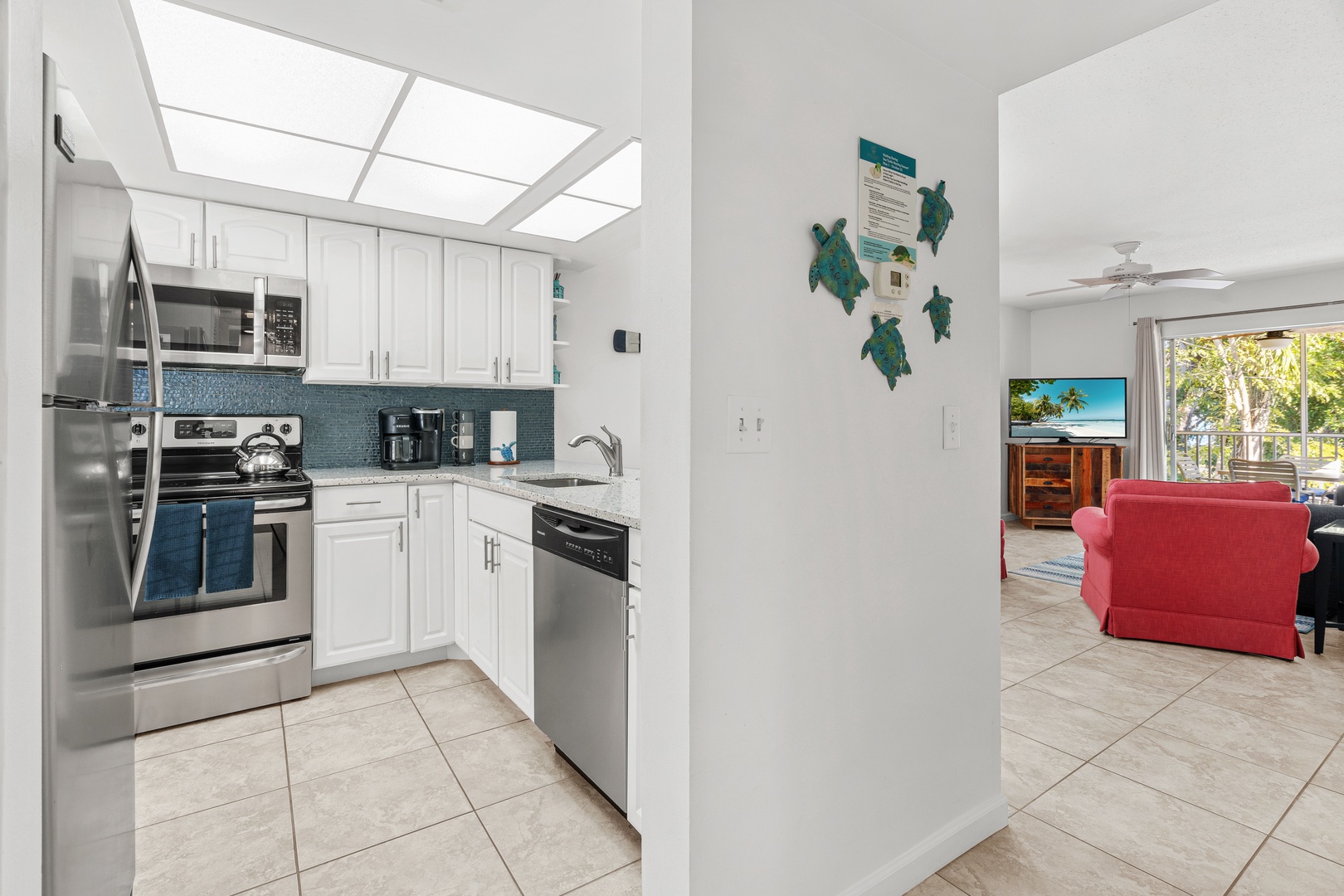 The spacious kitchen overlooks the open living area with private patio.