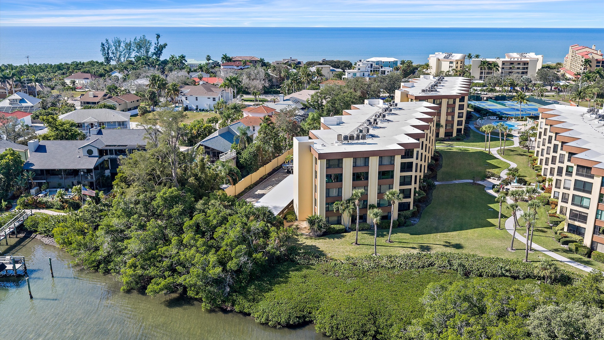Coastal resort community featuring modern condominiums nestled between tropical lagoons and pristine beachfront, offering a perfect blend of luxury and natural beauty.