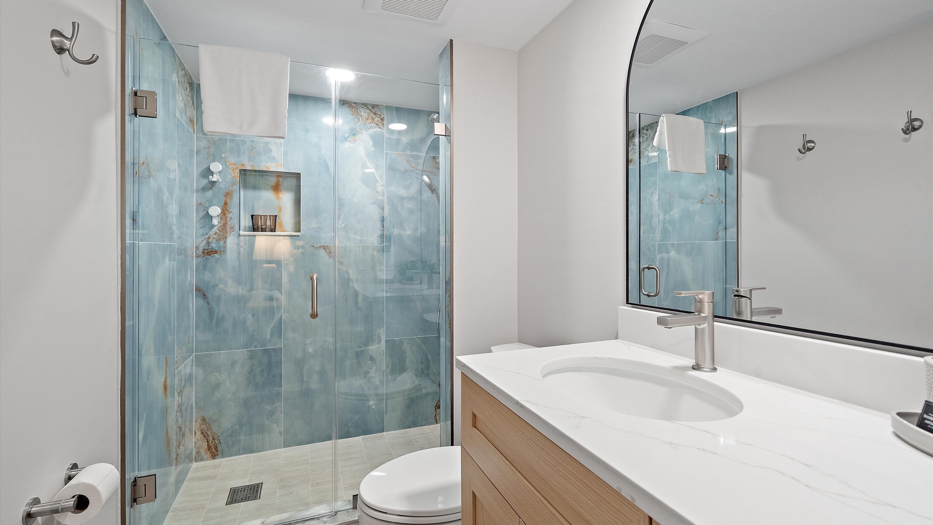 Your private spa-like bathroom features stunning blue marble tiles and a spacious glass shower where you'll start each morning refreshed.