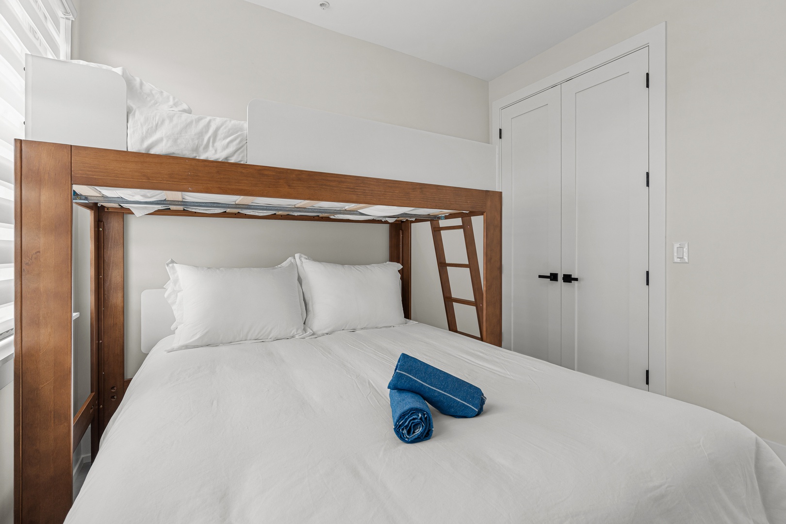 Settle into your cozy bedroom with a bunk bed setup perfect for families—crisp linens and plush towels await. You'll love the smart design and warm wood tones that make this space feel like home.